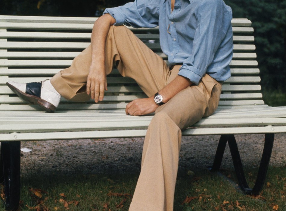 English singer Mick Jagger of the Rolling Stones sitting on a park bench in a panama hat and two-tone shoes, October 1973. (Photo by Anwar Hussein/Hulton Archive/Getty Images)